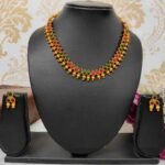 Unique Temple Design Ruby & Green Stone Golden Balls Matte Finish Necklace and Earring Set