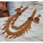Double Layered Matte Finish Ruby, Green Stone with Golden Balls Peacock Design Temple Haram Necklace With Earrings - Image 2