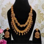 Double Layered Matte Finish Ruby, Green Stone with Golden Balls Peacock Design Temple Haram Necklace With Earrings